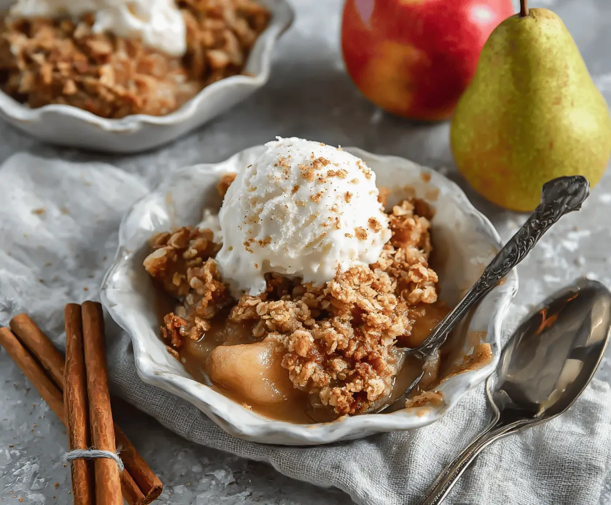 Delicious homemade apple pear crisp topped with golden brown oats and cinnamon, ready to serve as a comforting dessert.