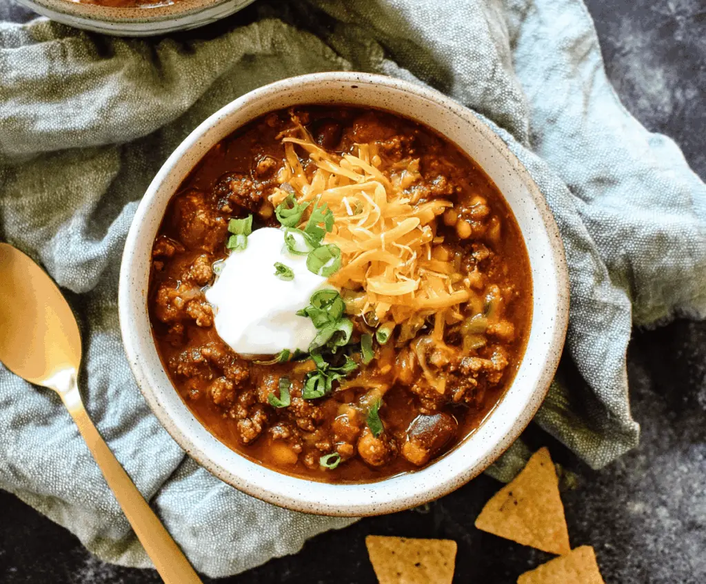 Delicious homemade stovetop chili with ground beef, beans, tomatoes, and spices in a pot, ready to serve