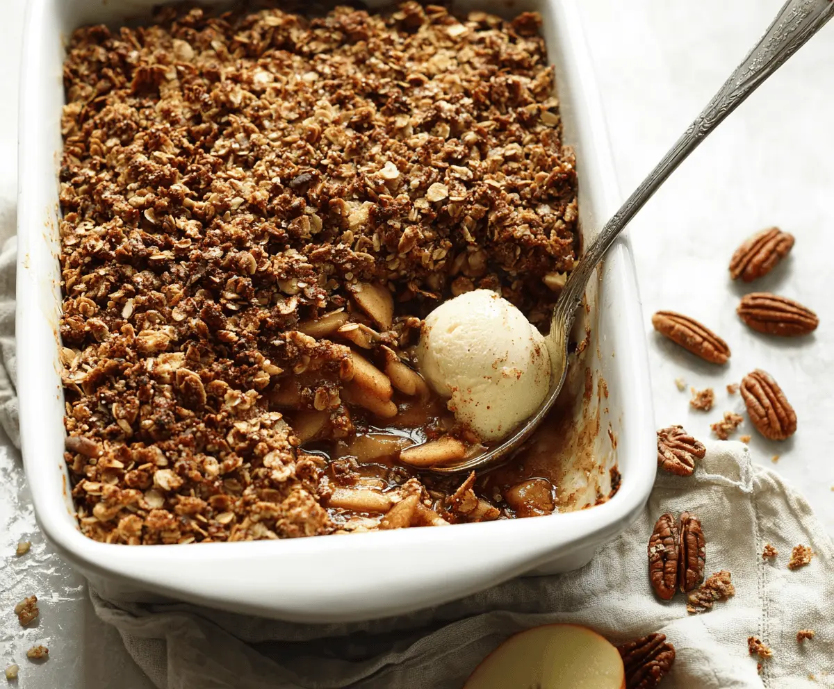 Delicious homemade vegan apple crisp topped with oats and cinnamon, served in a rustic dish, perfect for a healthy dessert