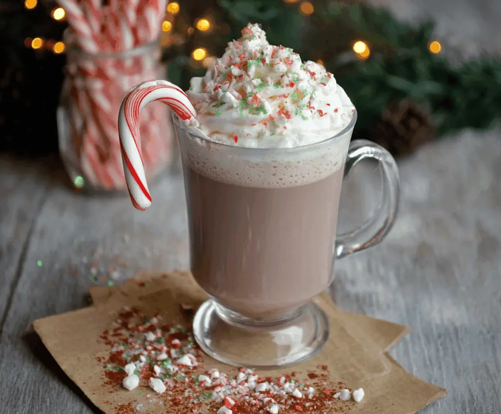 Creamy Candy Cane Hot Chocolate topped with whipped cream and crushed peppermint candies.