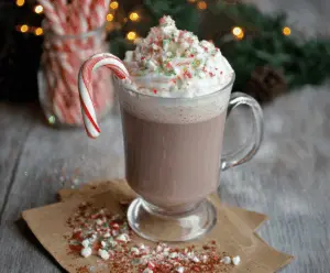 Creamy Candy Cane Hot Chocolate topped with whipped cream and crushed peppermint candies.