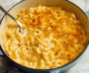 Creamy Paula Deen's Mac and Cheese served in a rustic dish, topped with golden melted cheese.