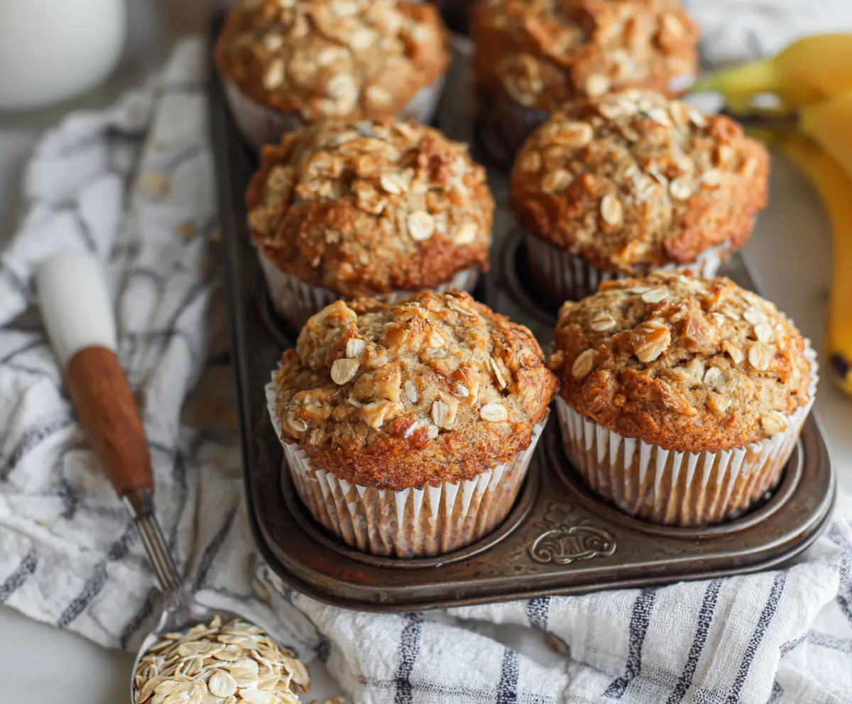 Delicious homemade banana oat muffins with golden-brown tops, perfect for breakfast or snacks.