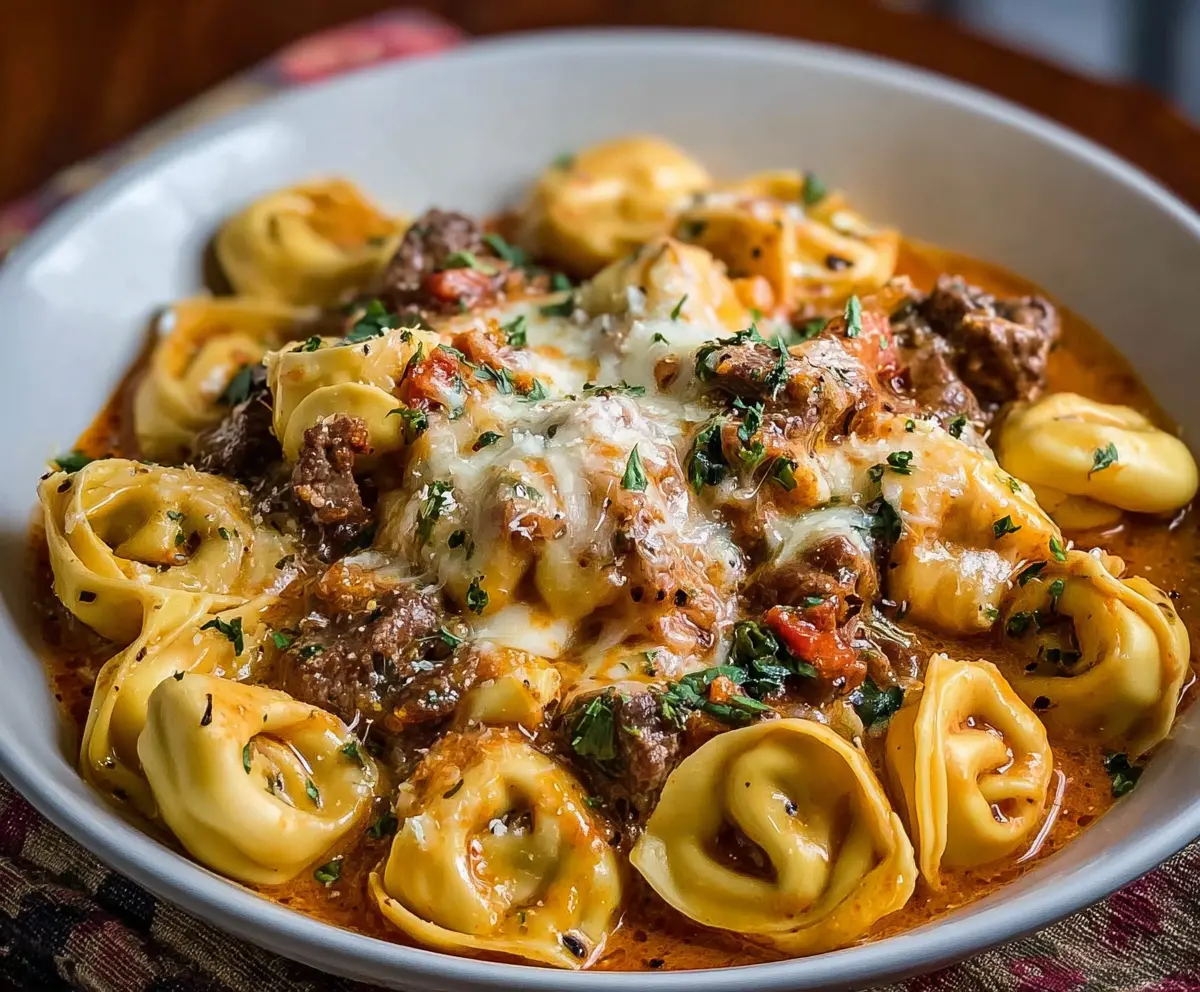 Delicious Cheesesteak Tortellini pasta dish with melted cheese and savory beef slices.