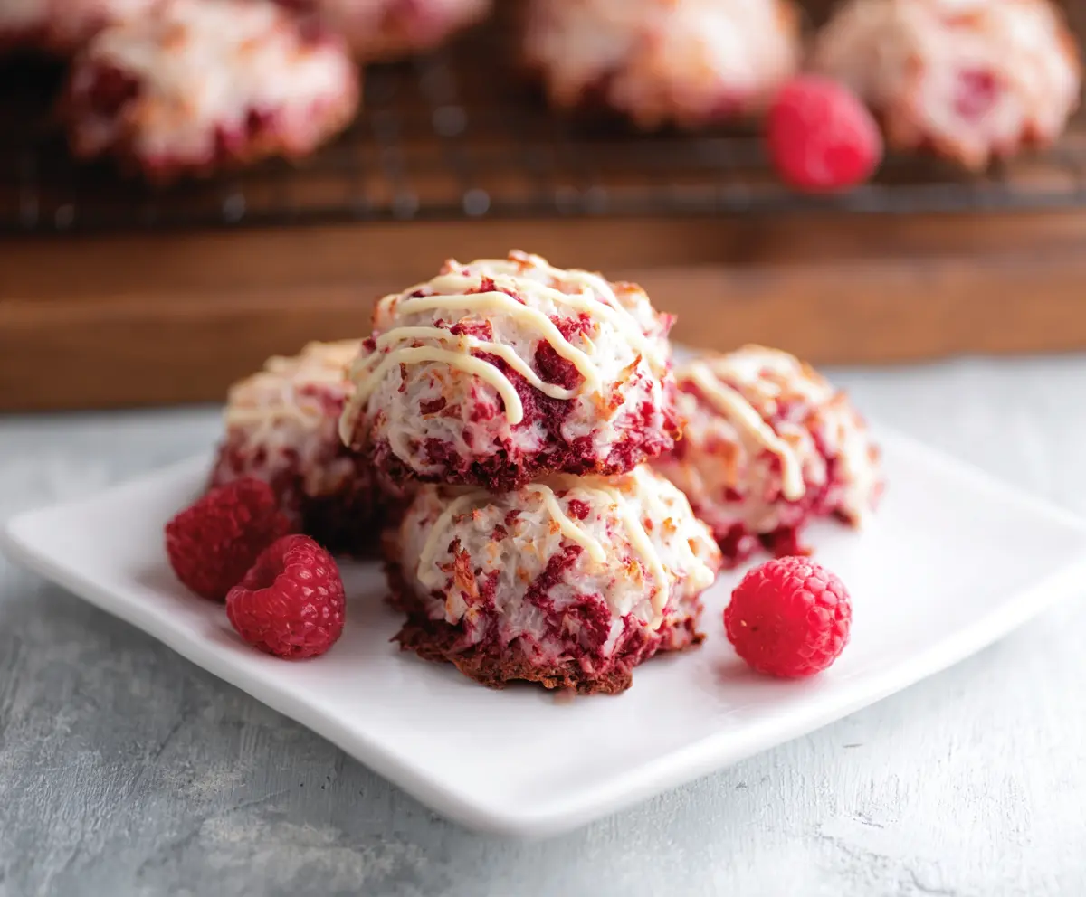 Delicious Raspberry Coconut Macaroons cookies with a golden-brown exterior and vibrant raspberry filling.