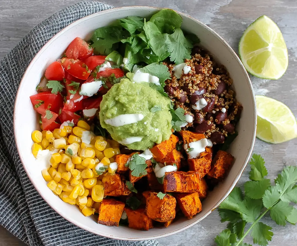 Colorful sweet potato taco bowls topped with fresh vegetables and herbs, perfect for a healthy meal.