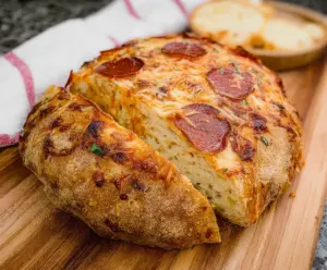 Delicious cheesy pepperoni sourdough pizza bread with melted cheese and spicy pepperoni slices.