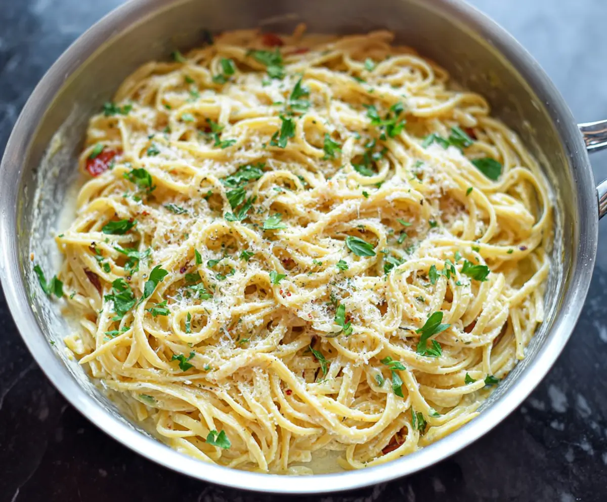 Delicious one-pan garlic Parmesan pasta served on a rustic wooden table.