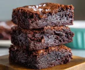 Delicious sourdough discard fudgy chocolate brownies on a plate with melted chocolate drizzle