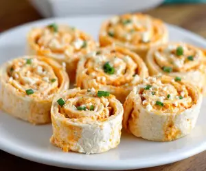 Delicious Buffalo Chicken Pinwheels with spicy sauce and creamy filling on a serving plate.