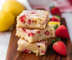 Delicious Lemon Strawberry Blondies garnished with fresh strawberries and lemon zest, perfect for summer desserts.