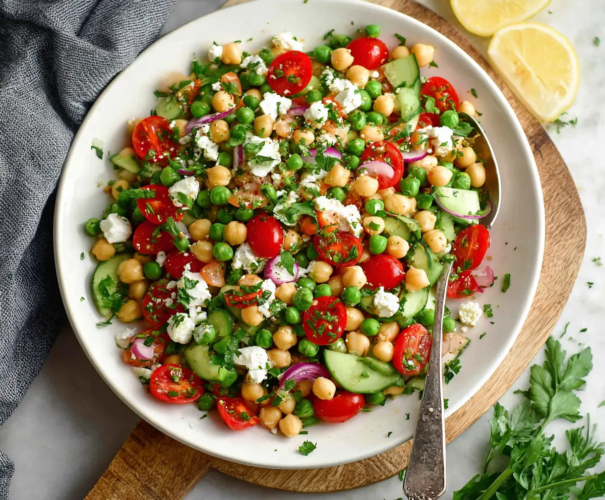 Fresh Mediterranean Pea Salad in a bowl with olives, feta cheese, and herbs, perfect for healthy eating.