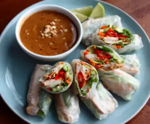 Delicious pork spring rolls crispy and golden served with a refreshing peanut lime sauce.