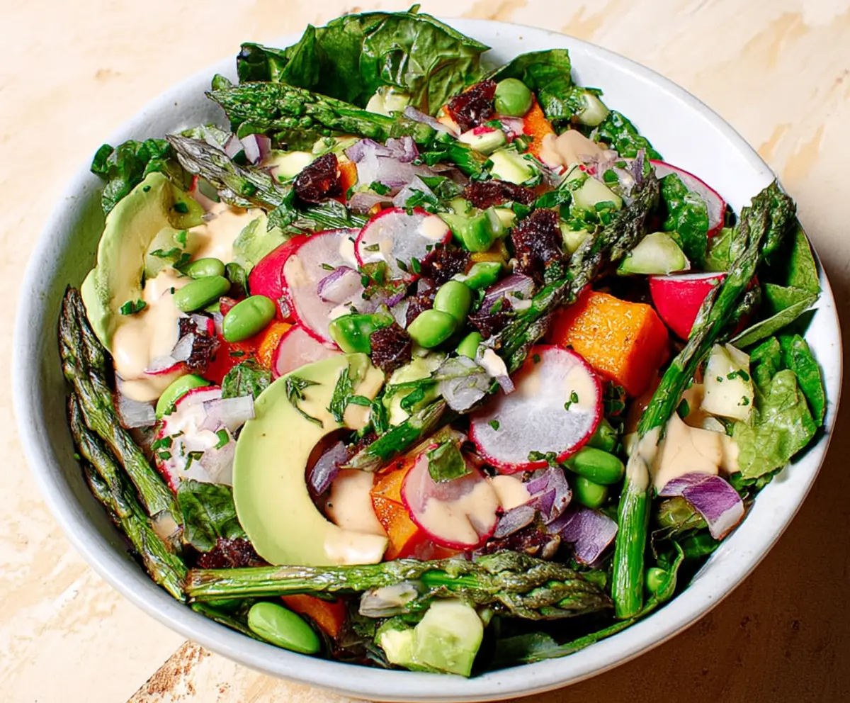 Colorful Spring Chopped Salad with fresh vegetables and herbs in a bowl.