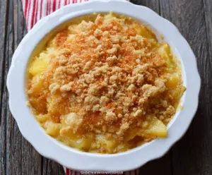 Delicious Sweet and Sour Pineapple Casserole served in a baking dish with pineapple chunks and a golden sauce.